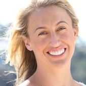 A smiling woman showing off her newly restored teeth